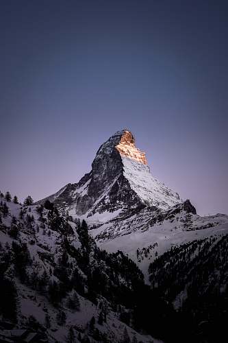 mountain range mountain coated with snow outdoors